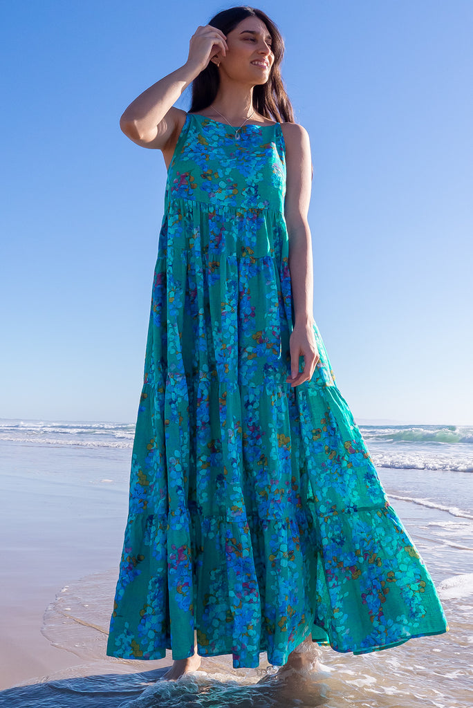The Lulu Darling Blue Bubble Maxi Dress is a beautiful blue wash effect based dress with a multicoloured bubble print. The maxi dress features a high neck with thin straps, high cut under arms, full tiered skirting from the bust down and deep side pockets. Made from a cotton / rayon woven blend.