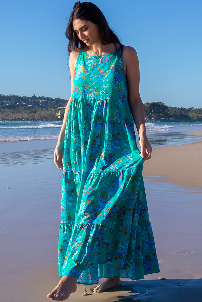 The Lulu Darling Blue Bubble Maxi Dress is a beautiful blue wash effect based dress with a multicoloured bubble print. The maxi dress features a high neck with thin straps, high cut under arms, full tiered skirting from the bust down and deep side pockets. Made from a cotton / rayon woven blend.