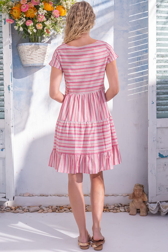 The Marini Popsicle Stripe Lei Mini Dress is a gorgeous pink striped mini dress. The dress features waist tabs at the back, short sleeves and tiered skirting. Made from 100% cotton. 