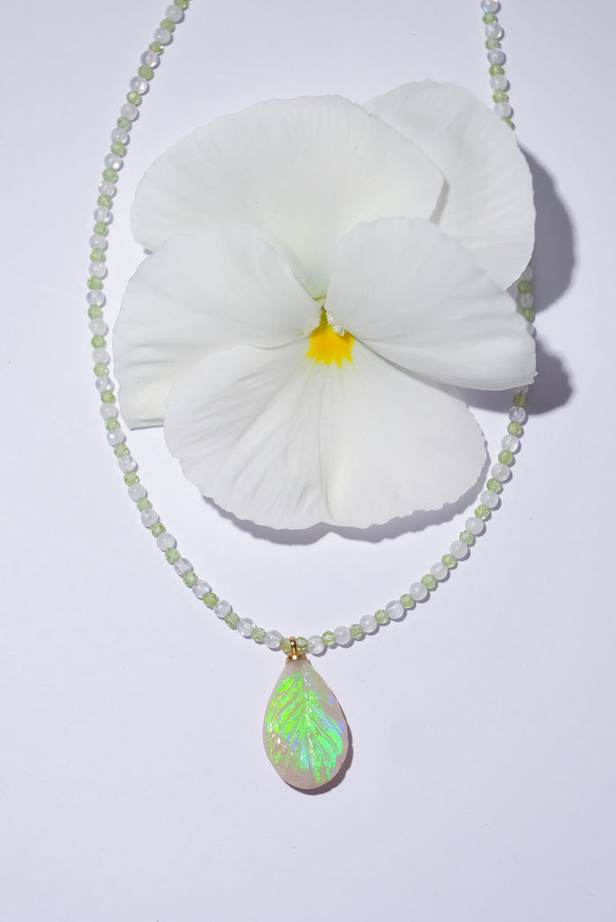 The enchanting soft green flashes of colour in this stunning opal leaf pendant are perfectly&nbsp;complimented by the delicate green of peridot and the magical shimmer of moonstone.