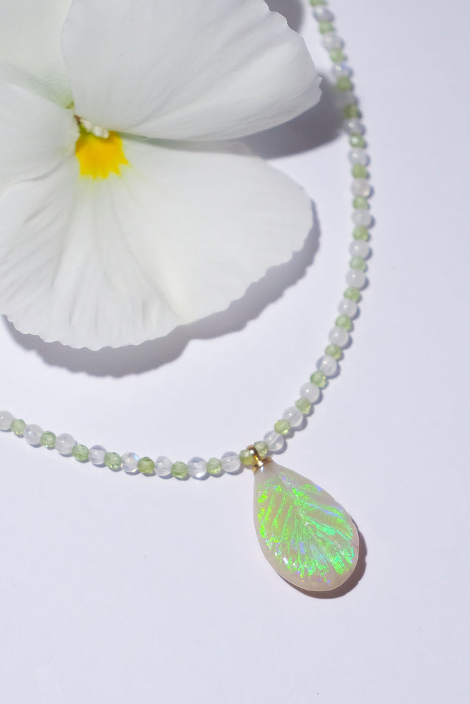 The enchanting soft green flashes of colour in this stunning opal leaf pendant are perfectly&nbsp;complimented by the delicate green of peridot and the magical shimmer of moonstone.