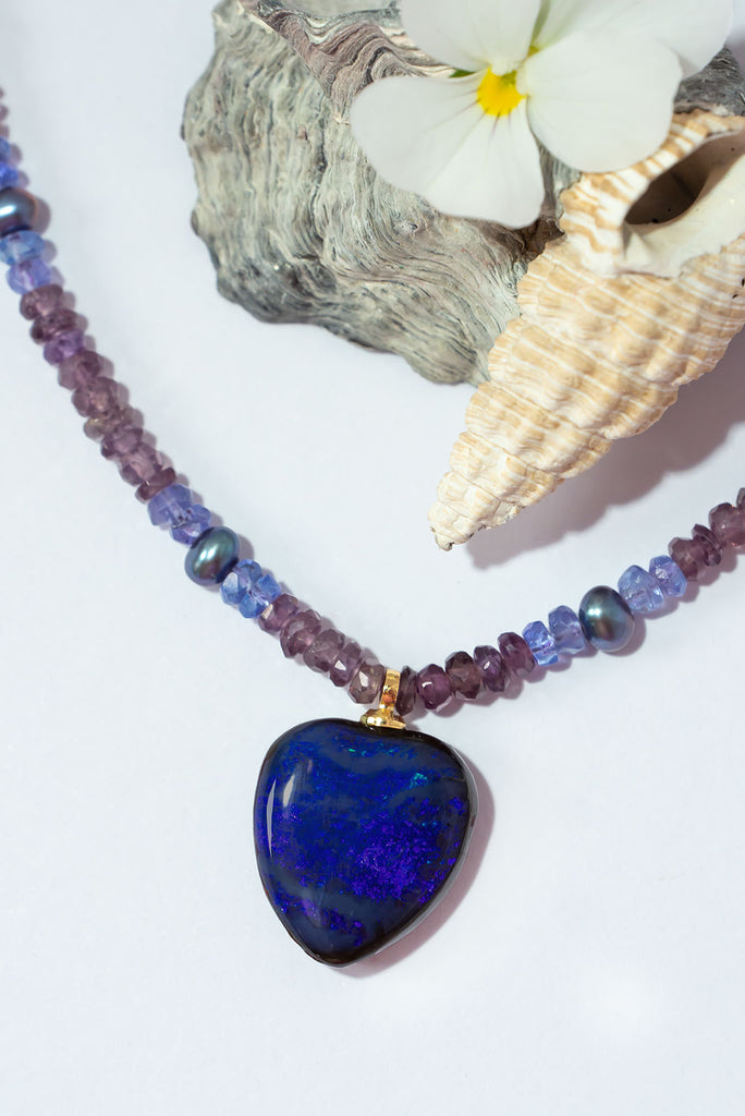 Get lost in the mesmerizing shades of violet, lavender and deepest purple featured in this gorgeous gemstone & opal necklace.