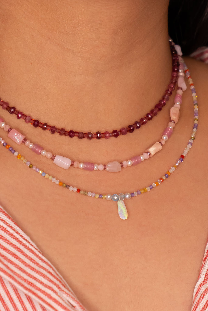 The tiniest delicate and pretty opal pendant, a little crystal droplet of ancient water hung from a rainbow of colour.