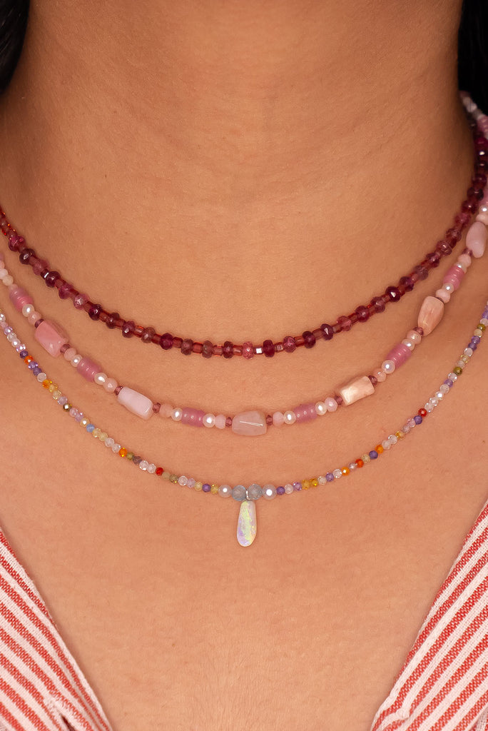 The tiniest delicate and pretty opal pendant, a little crystal droplet of ancient water hung from a rainbow of colour.