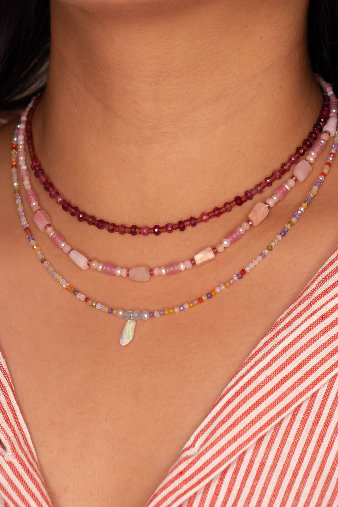 The tiniest delicate and pretty opal pendant, a little crystal droplet of ancient water hung from a rainbow of colour.