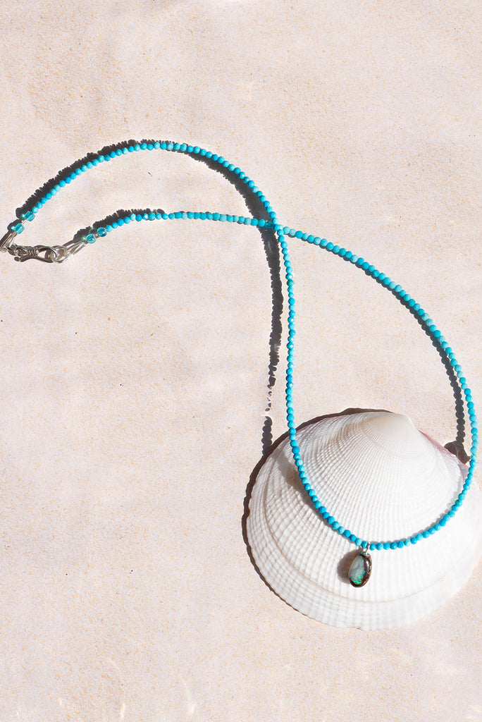 Inspired by the bright blue Summer skies of Noosa this delicate necklace features a dainty Australian boulder opal.