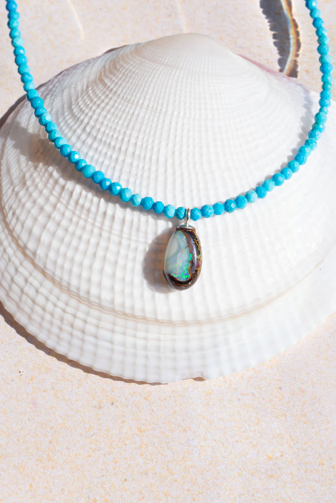 Inspired by the bright blue Summer skies of Noosa this delicate necklace features a dainty Australian boulder opal.