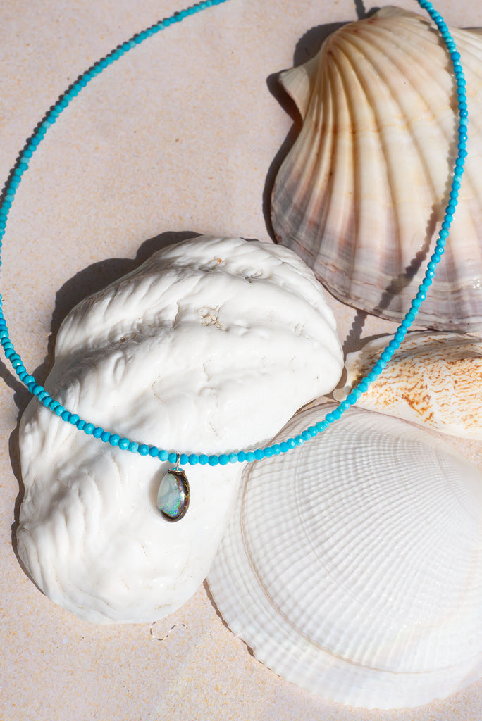 Inspired by the bright blue Summer skies of Noosa this delicate necklace features a dainty Australian boulder opal.