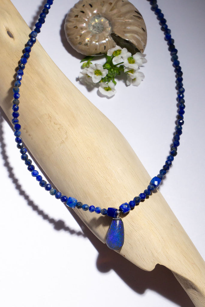 A bright splash of blue, a solid black opal with the intensity of bright cobalt blue deep in the stone, on a deep blue Lapis Lazuli tiny faceted bead necklace.