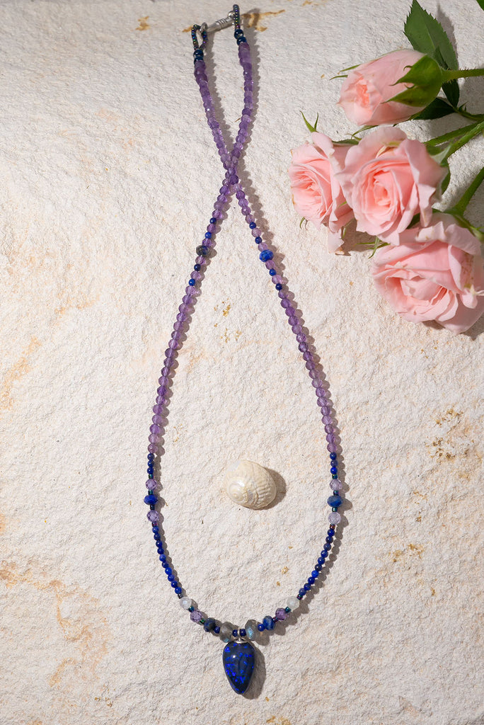 Get lost in the swirling indigo hues of this enchanting necklace.