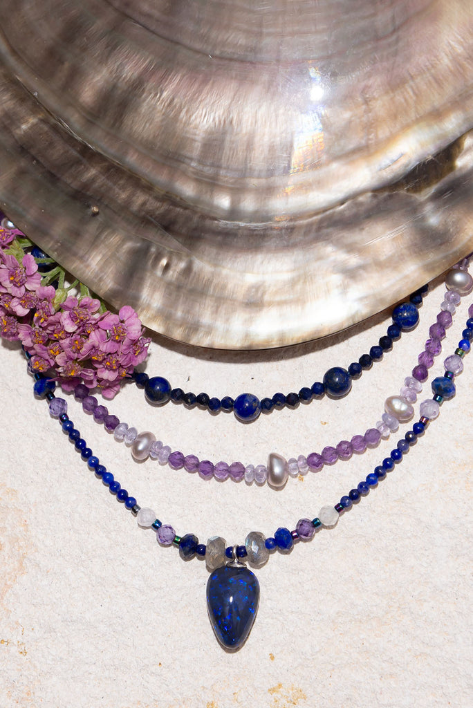 Get lost in the swirling indigo hues of this enchanting necklace.