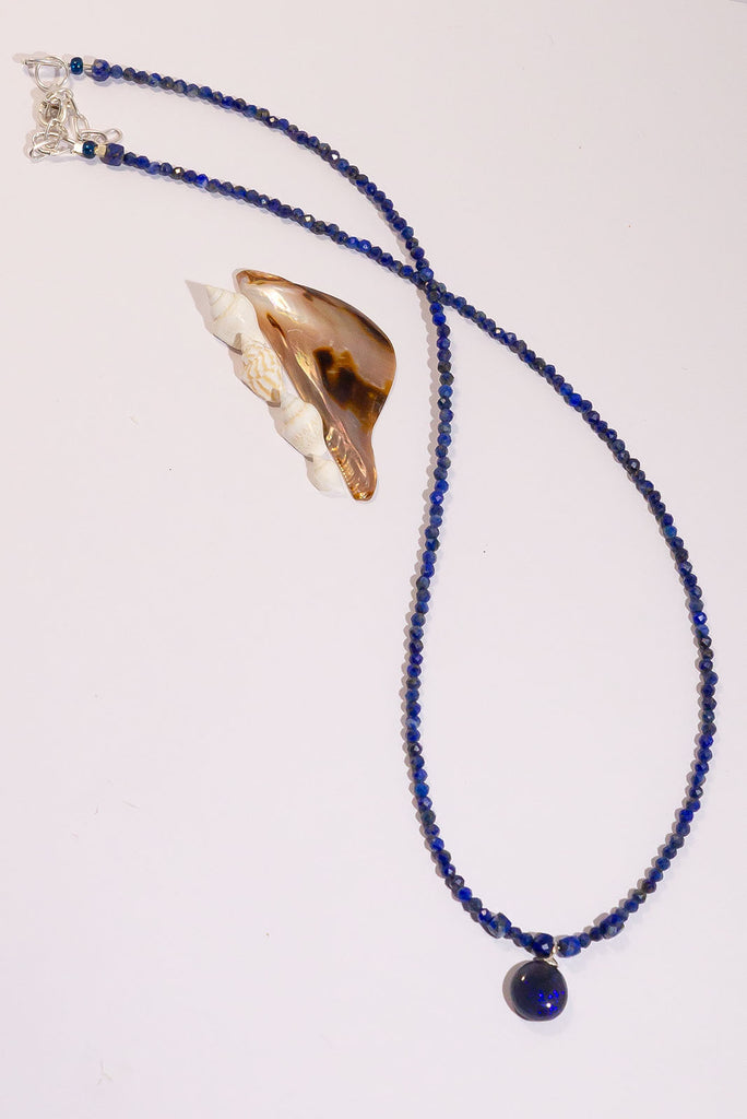 Get lost in the glittering galaxy of colour play in this enchanting opal necklace.