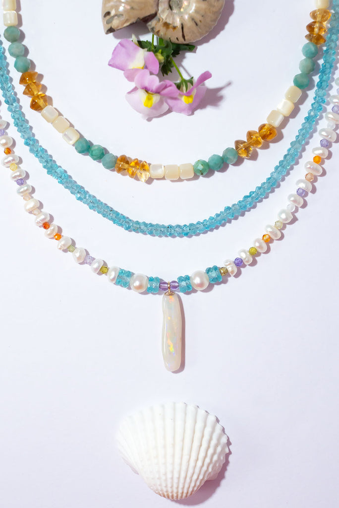 Like a rainbow of water droplets, this Australian Mintabie Opal flashes gold, deep pink and green, tiny pearls interspaced with sparkling faceted gemstone beads on the necklace.