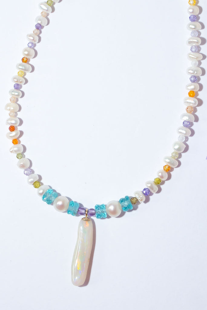 Like a rainbow of water droplets, this Australian Mintabie Opal flashes gold, deep pink and green, tiny pearls interspaced with sparkling faceted gemstone beads on the necklace.