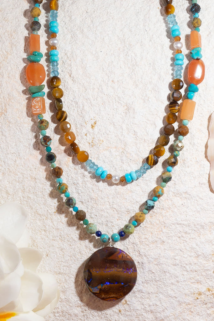 With its warm jewel tones and glittering boulder opal this enchanting necklace is reminiscent of a rainforest under a full moon.