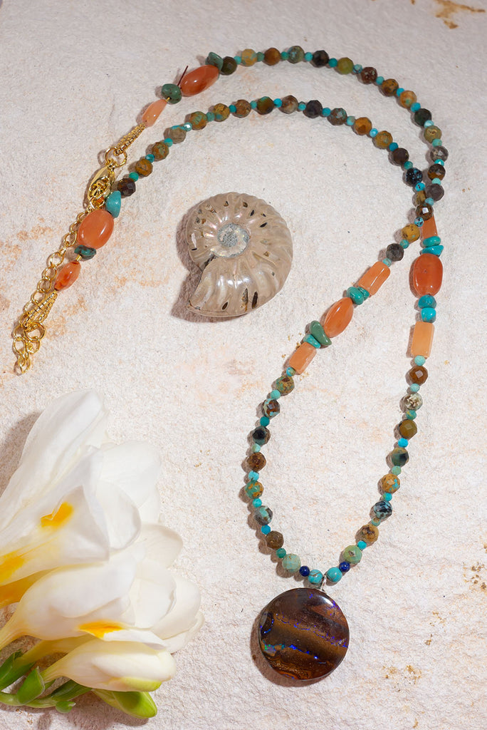 With its warm jewel tones and glittering boulder opal this enchanting necklace is reminiscent of a rainforest under a full moon.