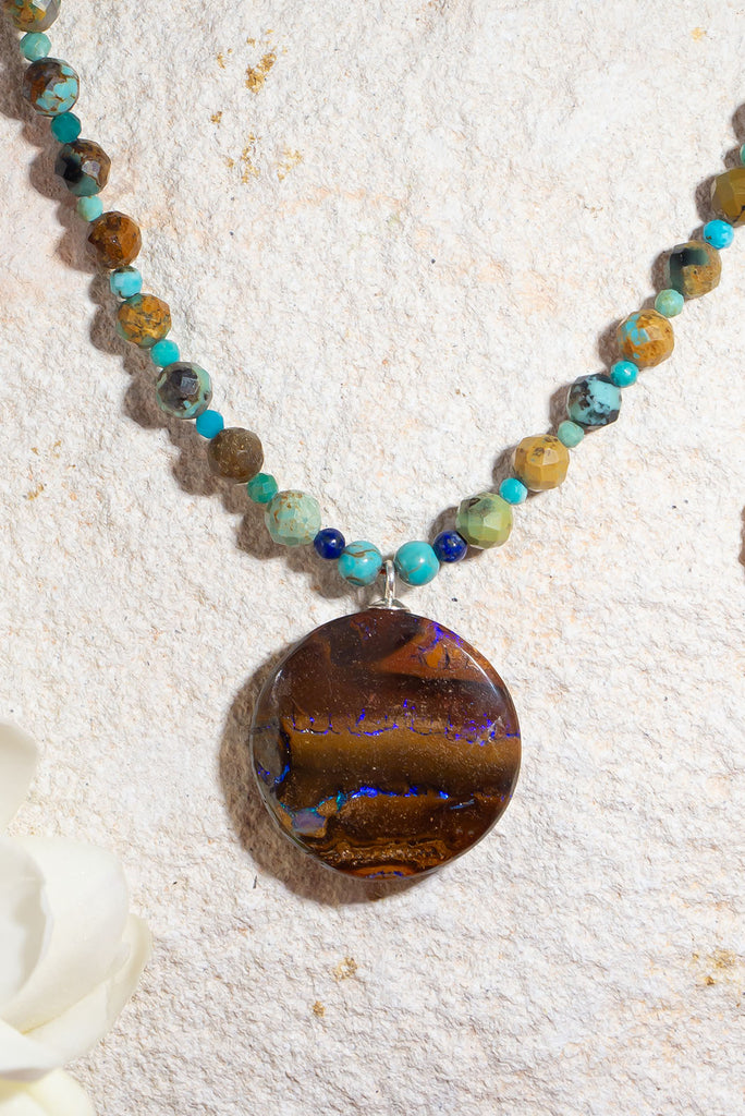 With its warm jewel tones and glittering boulder opal this enchanting necklace is reminiscent of a rainforest under a full moon.