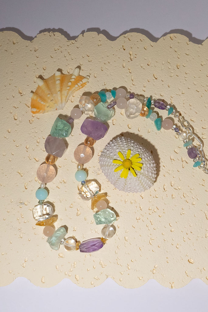 The Crystal Dream Necklace is designed and assembled using an assortment of new, old and repurposed material, each bead has a story to tell and together they are a powerful link to what was and what is to come. None of the stones are perfect, some are rough shards, some are village cut and some are highly polished.