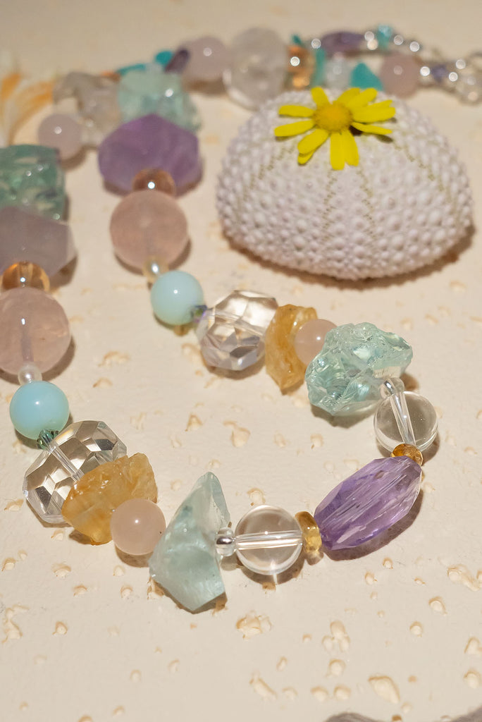 The Crystal Dream Necklace is designed and assembled using an assortment of new, old and repurposed material, each bead has a story to tell and together they are a powerful link to what was and what is to come. None of the stones are perfect, some are rough shards, some are village cut and some are highly polished.