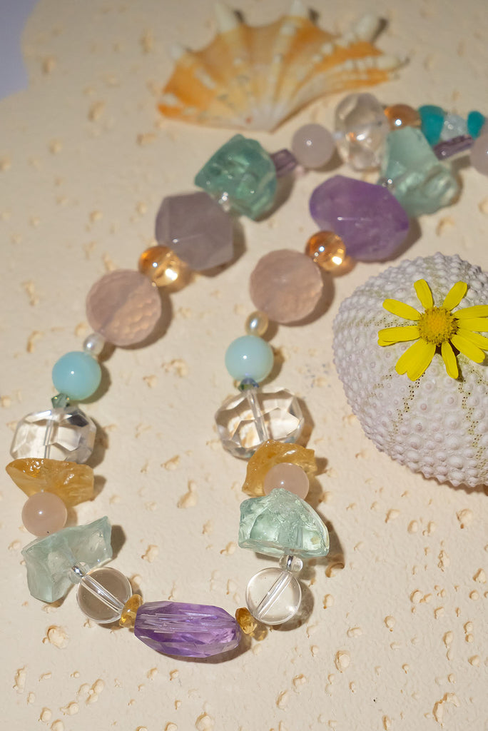 The Crystal Dream Necklace is designed and assembled using an assortment of new, old and repurposed material, each bead has a story to tell and together they are a powerful link to what was and what is to come. None of the stones are perfect, some are rough shards, some are village cut and some are highly polished.