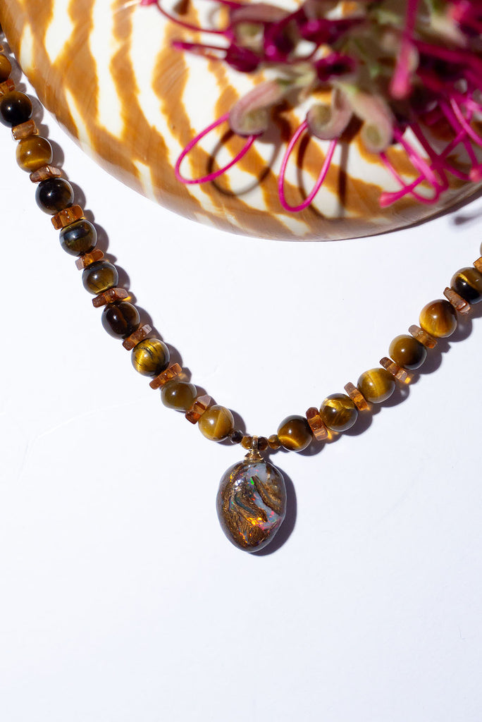 Discover the magic of Australian Matrix opal with our shimmering Necklace Gemstone Golden Sarabi. Every angle brings a different flash of colour with gold, red, green and dark blue all hiding within this gorgeous piece.