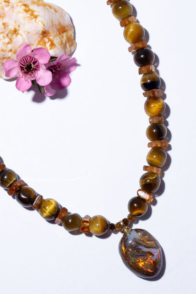 Discover the magic of Australian Matrix opal with our shimmering Necklace Gemstone Golden Sarabi. Every angle brings a different flash of colour with gold, red, green and dark blue all hiding within this gorgeous piece.