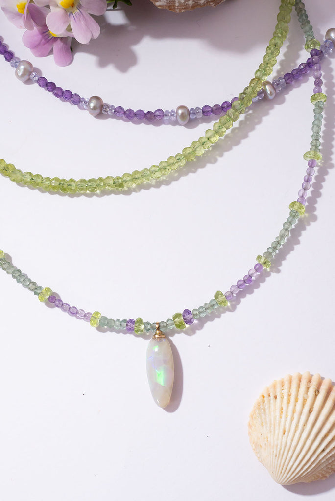With soft shades of leaf green and periwinkle this delicate gemstone necklace is reminiscent of a beautiful blooming Hydrangea.