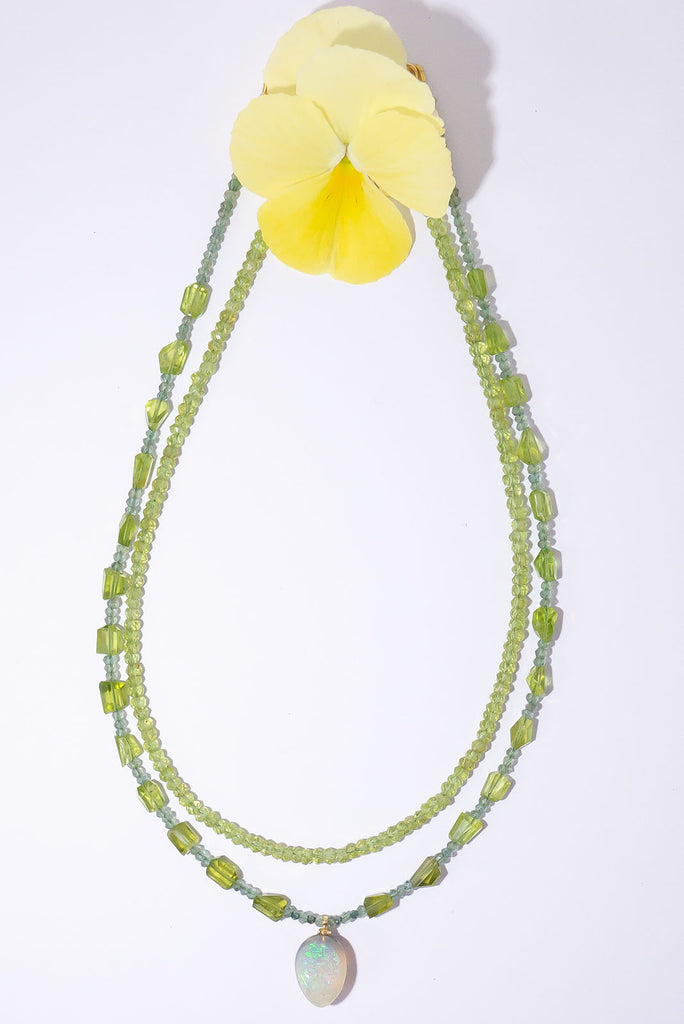 The gorgeous warm spring green of peridot, the shimmering sparkle of green diamonds and an enchanting Lightning Ridge Semi Black Opal come together to make a truly exception necklace.