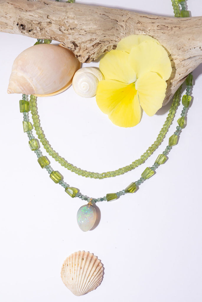 The gorgeous warm spring green of peridot, the shimmering sparkle of green diamonds and an enchanting Lightning Ridge Semi Black Opal come together to make a truly exception necklace.