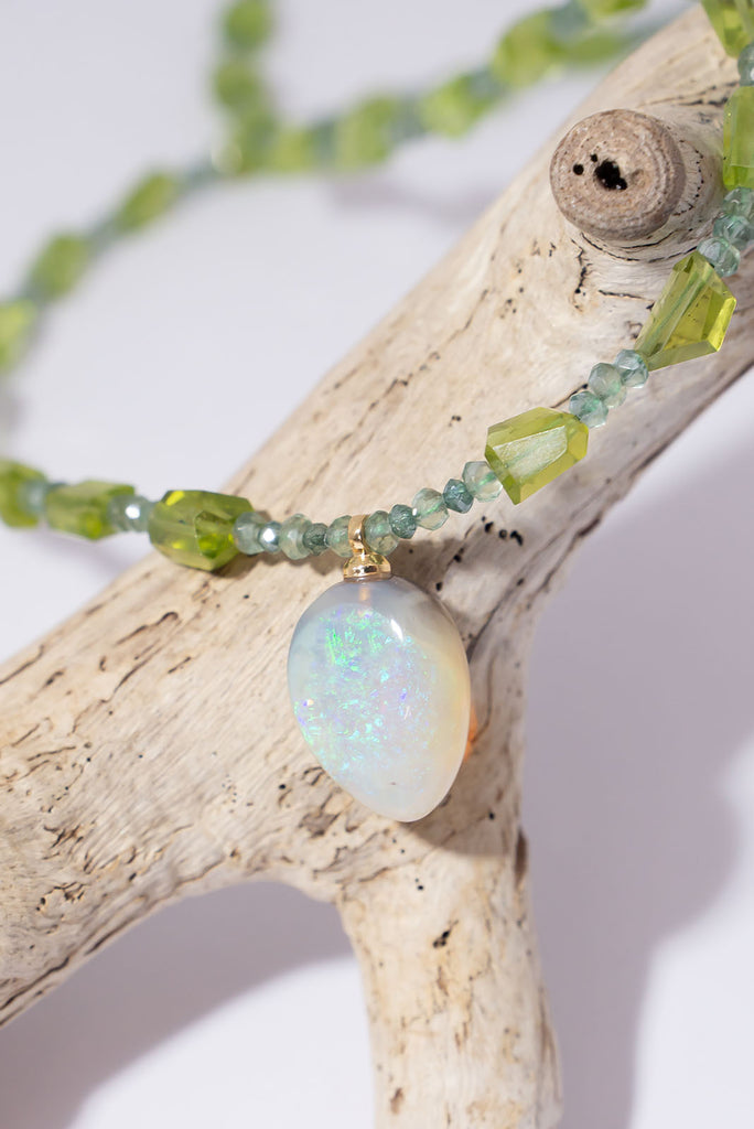 The gorgeous warm spring green of peridot, the shimmering sparkle of green diamonds and an enchanting Lightning Ridge Semi Black Opal come together to make a truly exception necklace.