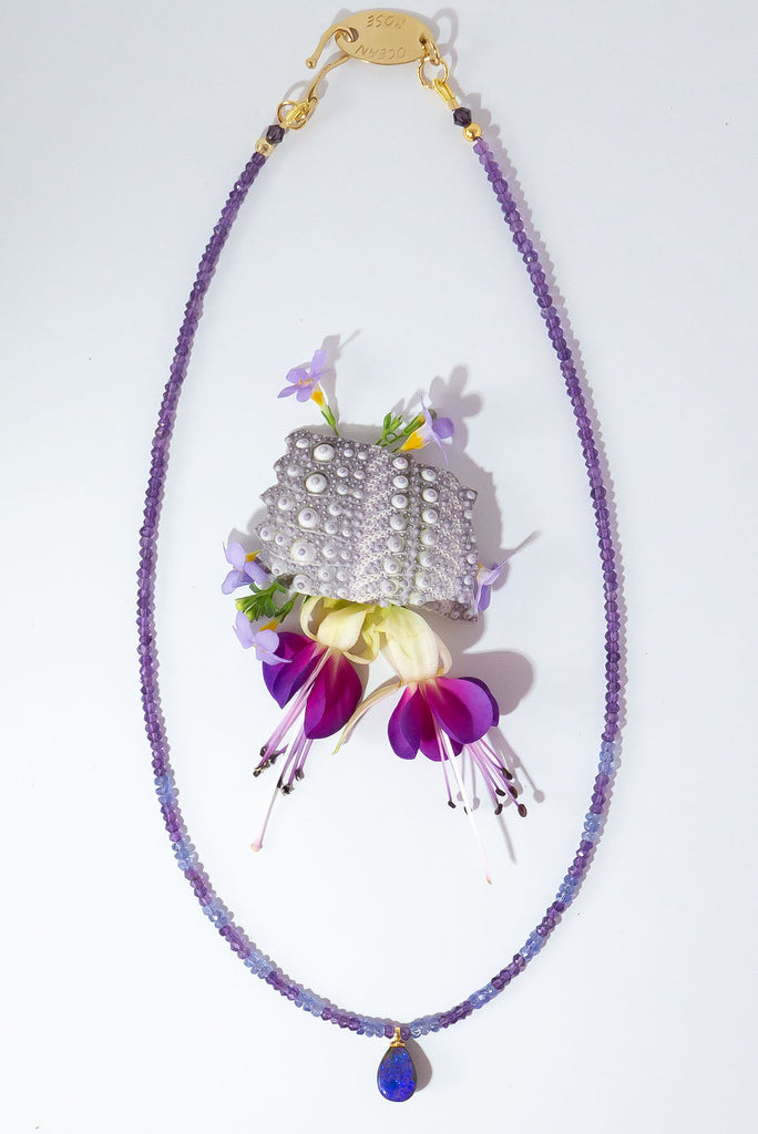 This magical pendant sparkles with blue flashes in a beautiful purple pool of opal. The stunning combination of amethyst & tanzanite is the perfect reflection of the opals shimmering colours.