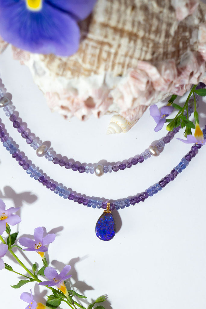 This magical pendant sparkles with blue flashes in a beautiful purple pool of opal. The stunning combination of amethyst & tanzanite is the perfect reflection of the opals shimmering colours.