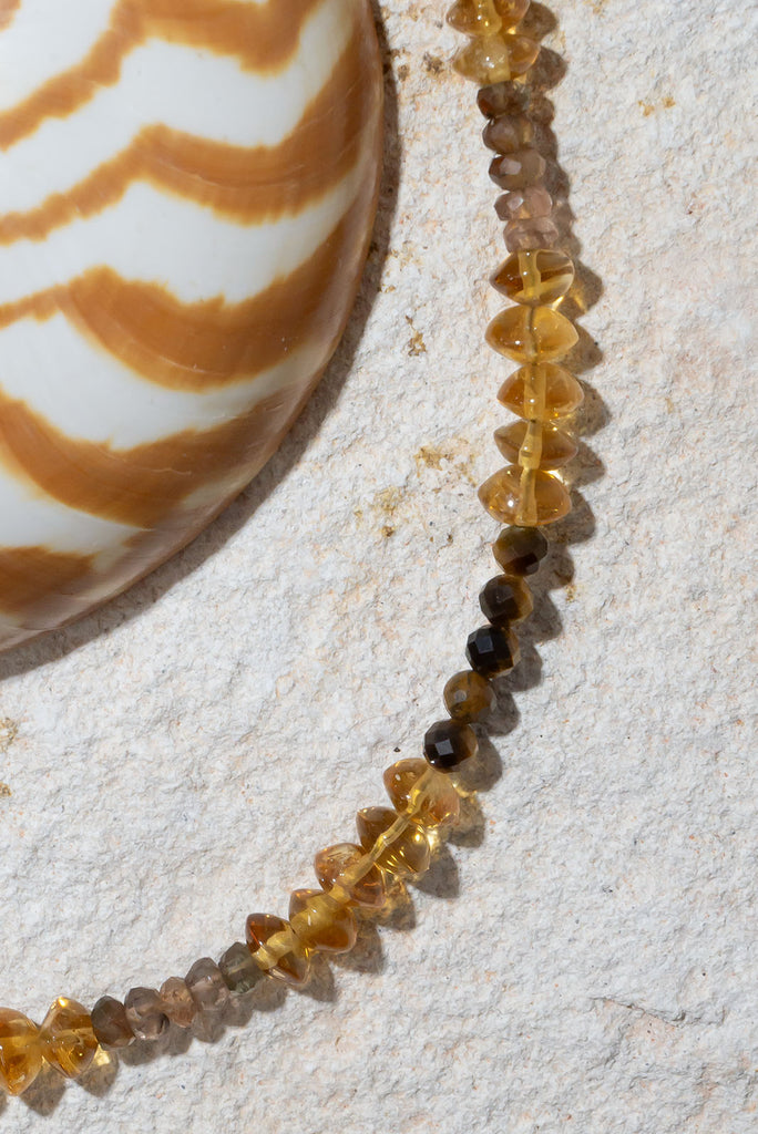 Inspired by the golden warm hues of a rolling desert. This gorgeous gemstone necklace features shimmer, sparkle and shine.