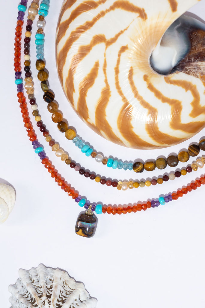 This delicate gemstone necklace features showing stopping jewel tones and a petite boulder opal pendant.