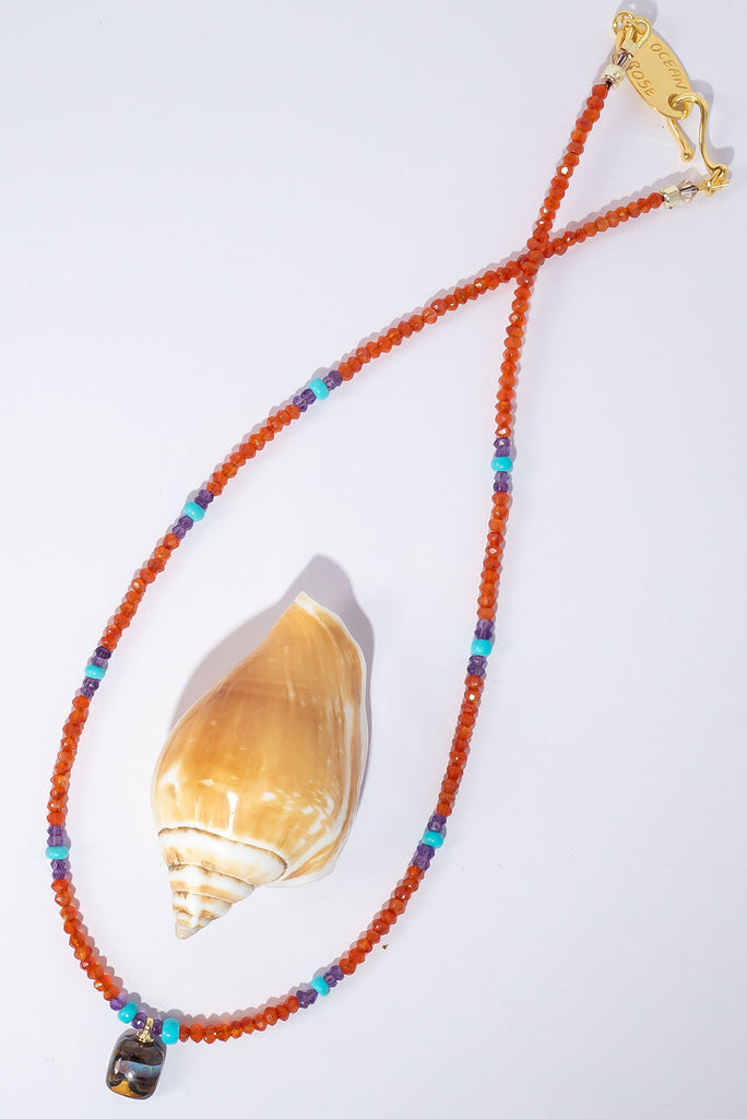 This delicate gemstone necklace features showing stopping jewel tones and a petite boulder opal pendant.