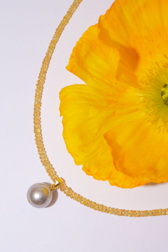 This warm toned shimmering gemstone necklace features a petite but special Australian boulder opal filled with a rainbow of colour play.