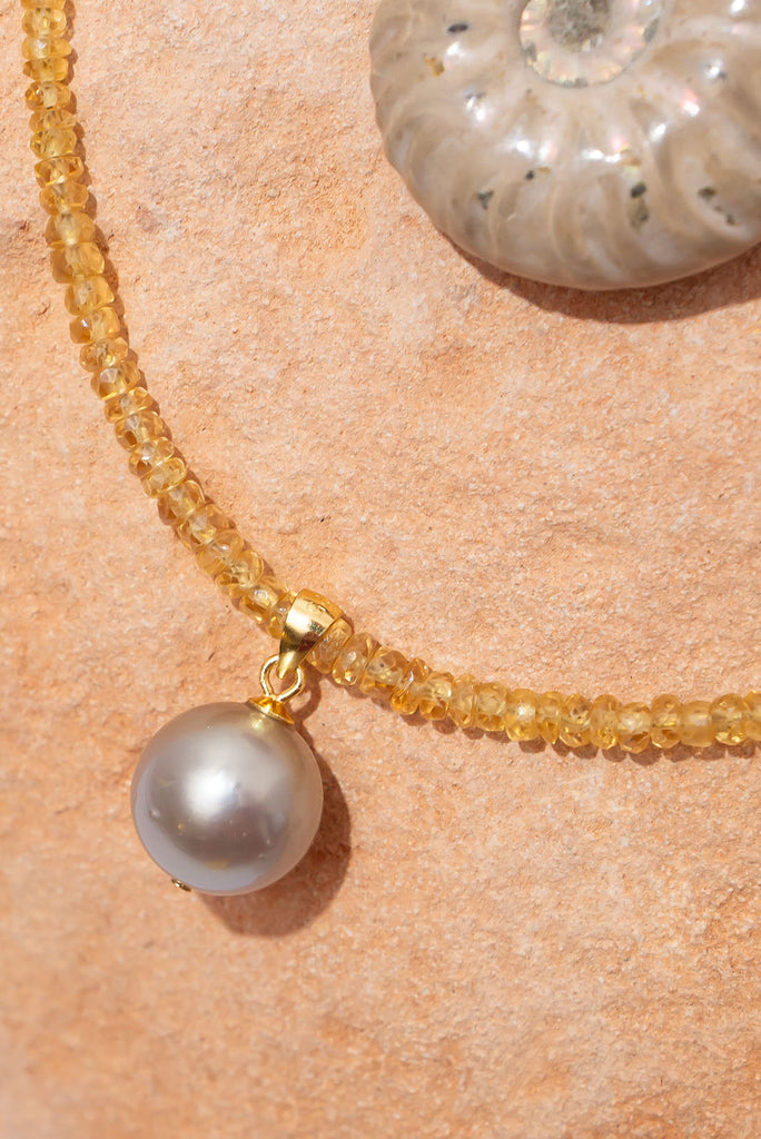 This warm toned shimmering gemstone necklace features a petite but special Australian boulder opal filled with a rainbow of colour play.