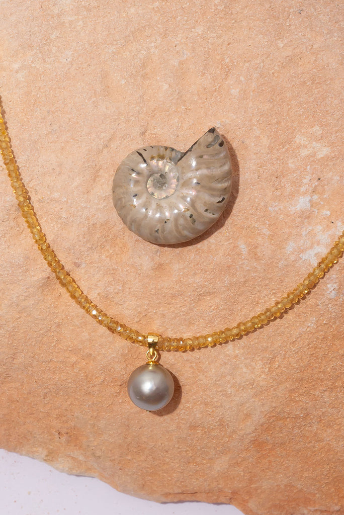 This warm toned shimmering gemstone necklace features a petite but special Australian boulder opal filled with a rainbow of colour play.