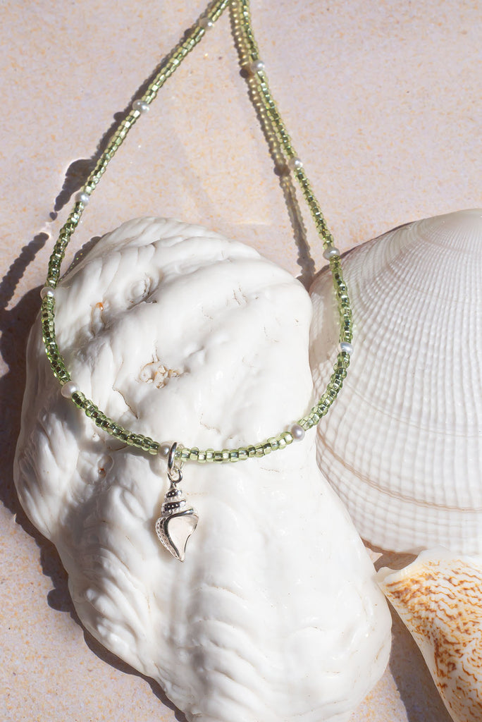 This delicate necklace shimmers and shines in the sunlight. It features an enchanting sterling silver seashell pendant.