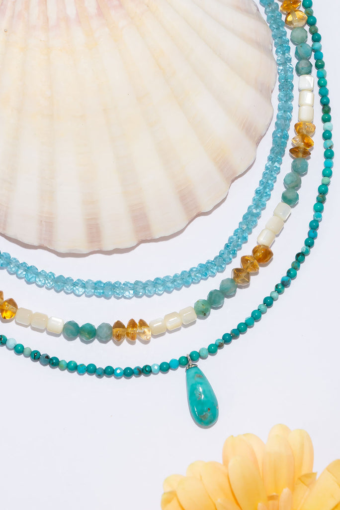 A tiny pop of intense turquoise, this turquoise bead and pendant necklace is absolute summer chic.
