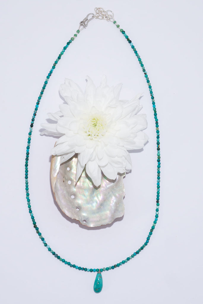 A tiny pop of intense turquoise, this turquoise bead and pendant necklace is absolute summer chic.
