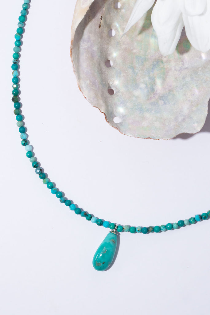 A tiny pop of intense turquoise, this turquoise bead and pendant necklace is absolute summer chic.