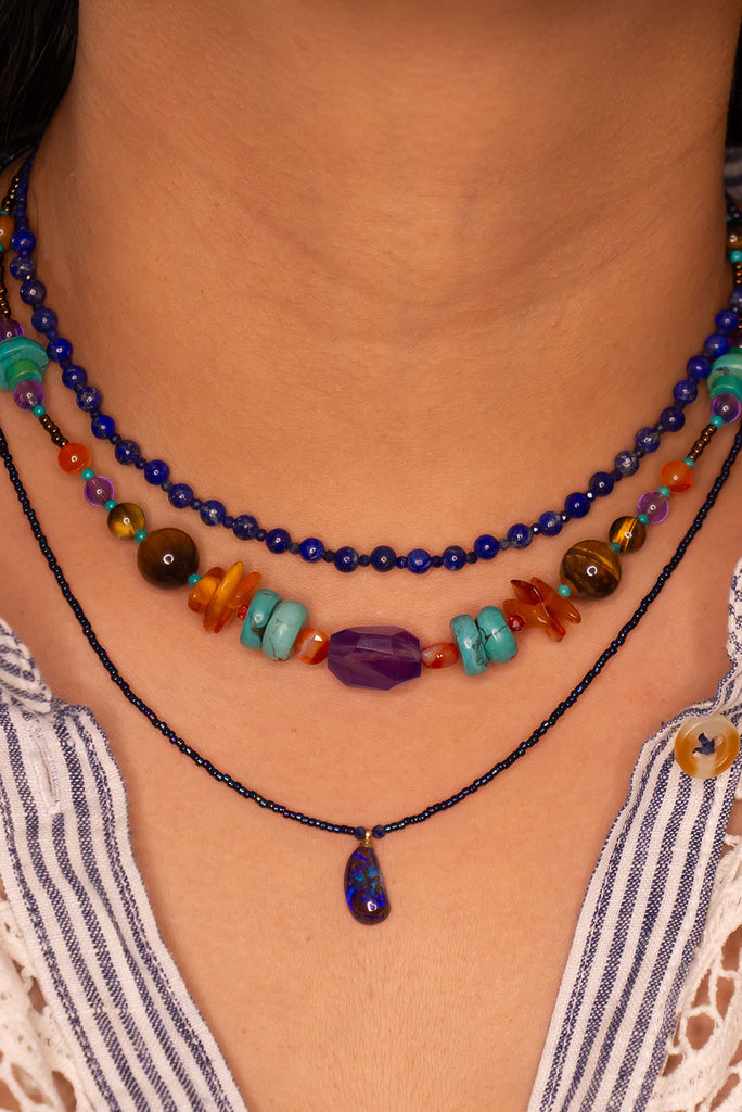 Such chic take on an opal necklace, a perfectly shaped swoop, this opal pendant has deep bright blue crystal mixed with the dark boulder, its organic and minimalist.