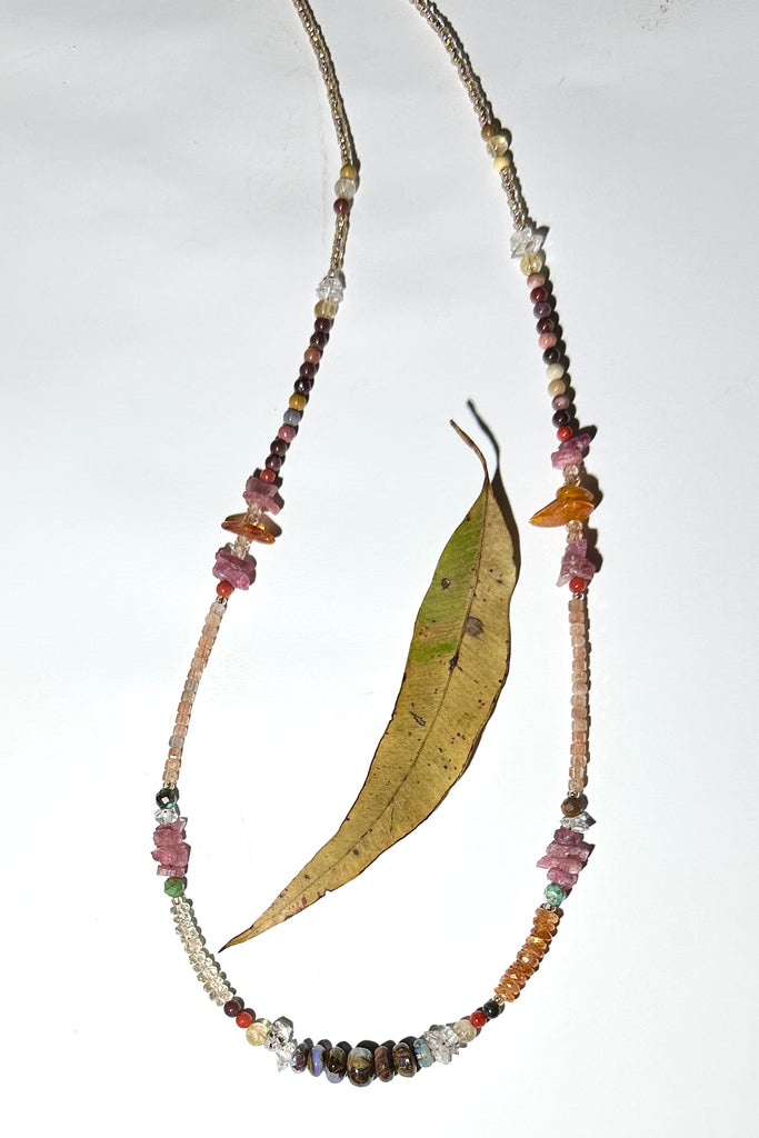 The colours of the Australian outback in gemstones. Inspired by a visit to Winton, I designed this sparkling and mystical necklace.

Australian gemstones incorporated are are Boulder Opal,&nbsp; Mookaite, Labradorite and Sunstone.
Also incorporated are Mandarin Garnet, Ruby rough beads, Baltic Amber, Herkimer Diamond, Turquoise, vintage Coral.