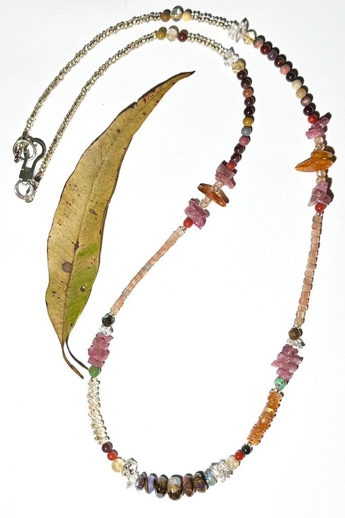 The colours of the Australian outback in gemstones. Inspired by a visit to Winton, I designed this sparkling and mystical necklace.

Australian gemstones incorporated are are Boulder Opal,&nbsp; Mookaite, Labradorite and Sunstone.
Also incorporated are Mandarin Garnet, Ruby rough beads, Baltic Amber, Herkimer Diamond, Turquoise, vintage Coral.