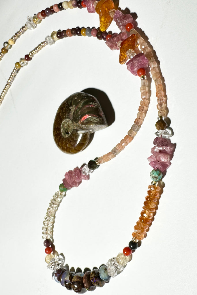 The colours of the Australian outback in gemstones. Inspired by a visit to Winton, I designed this sparkling and mystical necklace.

Australian gemstones incorporated are are Boulder Opal,&nbsp; Mookaite, Labradorite and Sunstone.
Also incorporated are Mandarin Garnet, Ruby rough beads, Baltic Amber, Herkimer Diamond, Turquoise, vintage Coral.