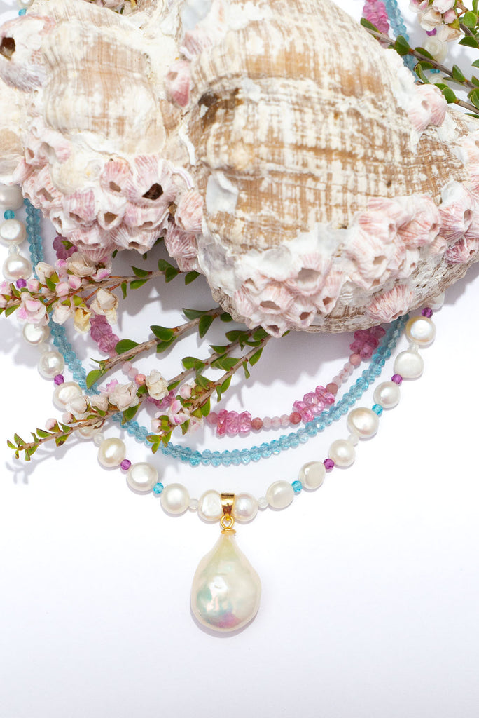 A pearl necklace with a South Pacific twist, luminescent creamy white pearls interspaced with turquoise, pink and white CZ beads, feel the calm of the island