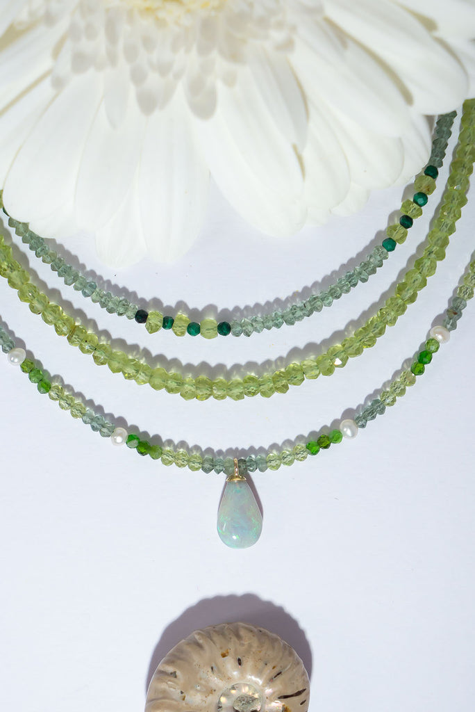 3 shades of soft sparkling green gemstones are the perfect complement for a delicate opal pendant that shimmers with gorgeous green fire.