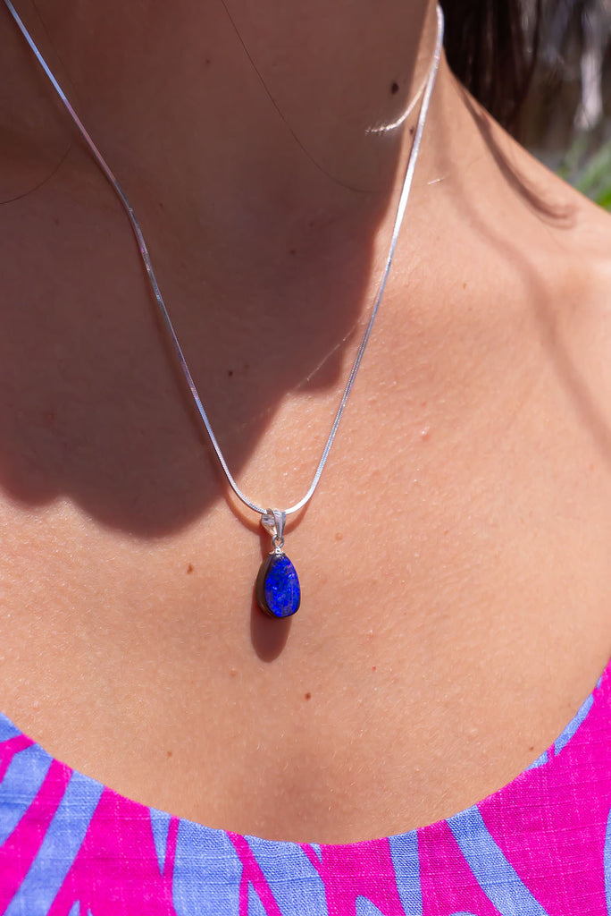 A Wonderful deep blue opal pendant, it has strong blue colour with some teal flashed in sunlight, polished to a high shine on the front and back.