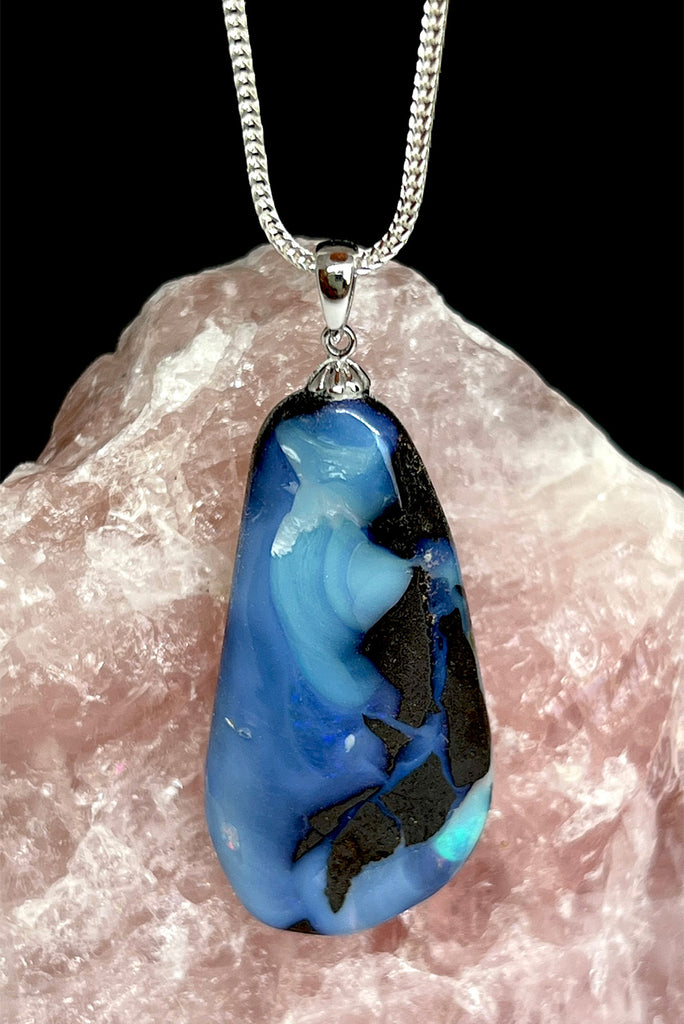A very organic natural opal piece with strong blue colour meeting the boulder down one side, it looks like the meeting of the sea and the shore.